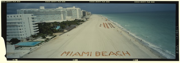 Aerial view of sunbathers forming the word Miami Beach on the beach next to the Fontainebleau and Sorrento Hotel - Negative: [Sun batherslaying in formation on the beach to spell out "Miami Beach"]