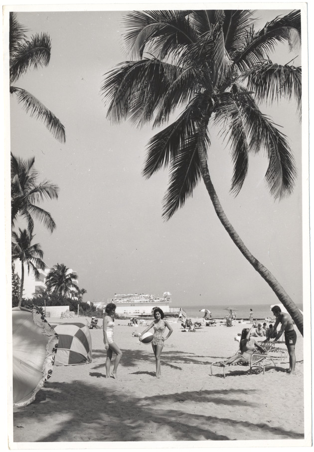 Beach scene with a hotel pool in the background, February 1960 - 