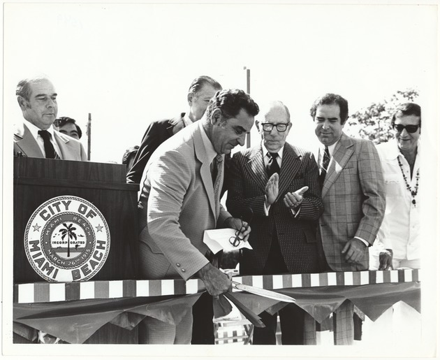 Miami Beach award ceremony scenes, 1970s and 1980s - Photograph, recto: [Ribbon cutting ceremony, L to R: Commissioner Marvin Engleman behind podium, Mayor Harold Rosen, Claude Pepper, Commissioners Leonard Haber and Murray Meyerson]