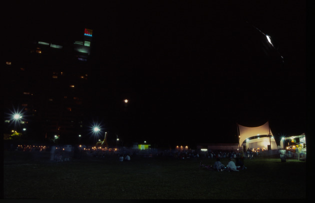 Night scene of a crowd at the bandshell - Image 1