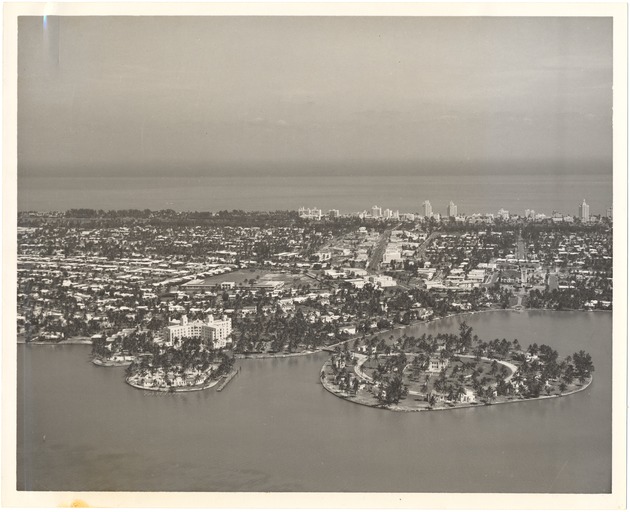 Miami Beach, 1925 and 1952 - Photograph, recto: [Aerial view of Miami Beach looking east with Nautilus Hotel in foreground, 1952]