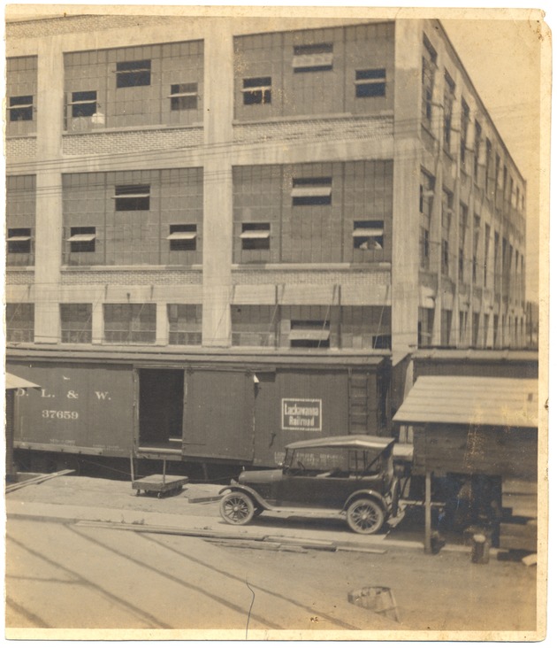 Delaware, Lackawanna & Western Railroad Company - Photograph, recto: [View of an automobile in front of a railroad train]