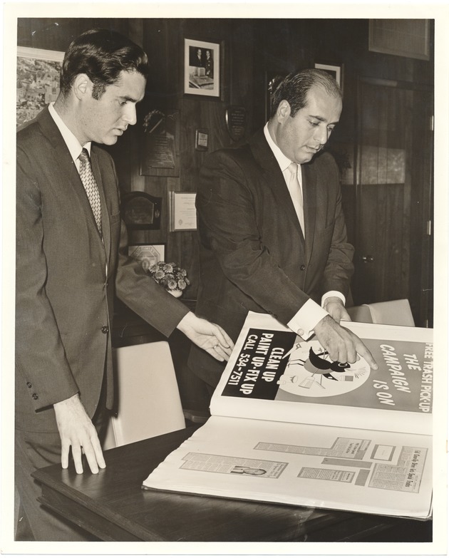 Miami Beach Mayors Jay Dermer and J.N. Lummus at city events, 1968 - Photograph, recto: [Paul Steinberg, Chairman of the Beautification Committe of the City of Miami Beach, and Mayor Jay Dermer looking at advertising materials, 1968]