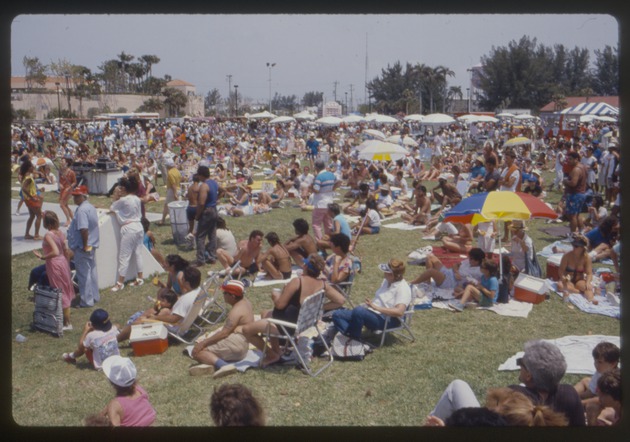 People sit on grass at Miami Beach Festival of the Arts
