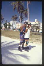 Rollerblading man and woman at park