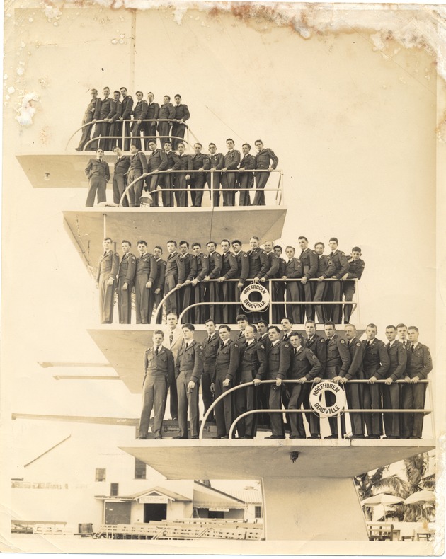 Posed portrait of young men/soldiers on diving board at the MacFadden Deauville Hotel - Recto Photograph