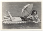 Valerie Jackson floating in the water with a parasol
