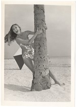 Dominique Doherty grabbing a palm tree by the trunk