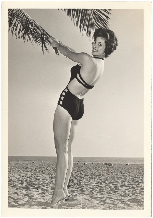 Nikki O'Conner posing with a palm tree - 