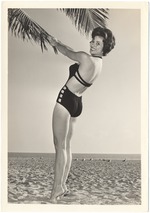 Nikki O'Conner posing with a palm tree