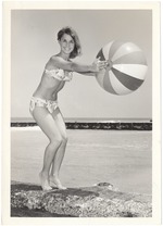 Jacki Modisette extending a beach ball into the water