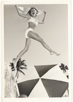 Cynthia Williams jumping with a scarf in over an umbrella