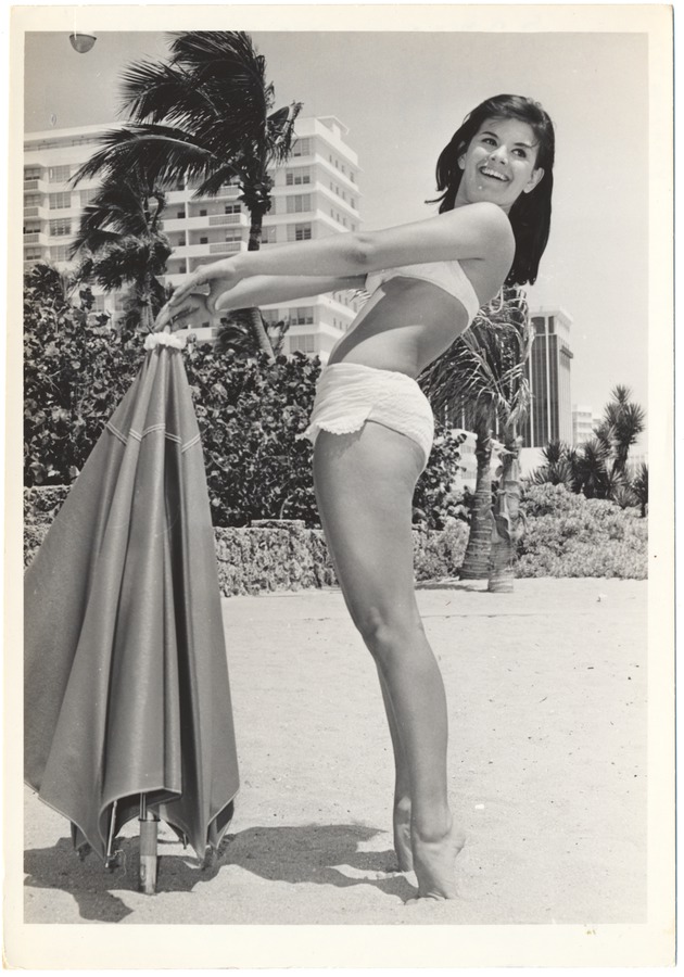 Donna Rankin placing an umbrella in the ground - 