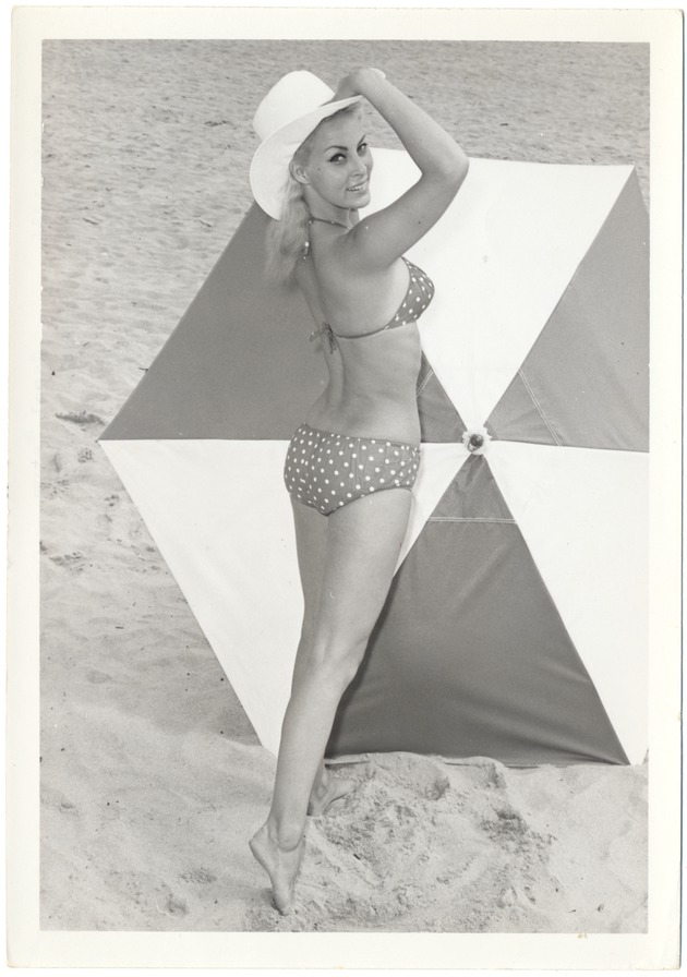 Carol Tatum with an umbrella in the sand - 