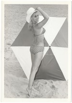 Carol Tatum with an umbrella in the sand