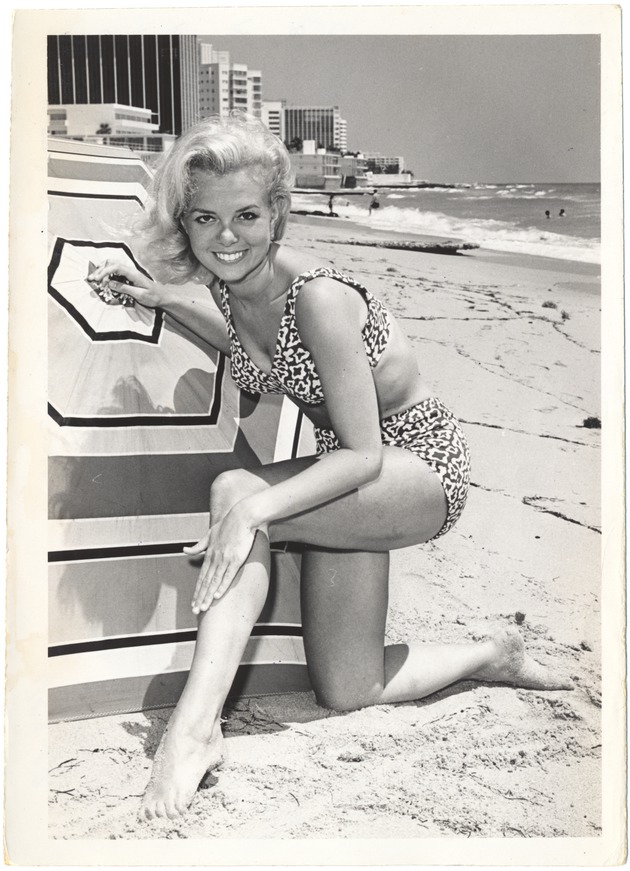 Joyce Scott kneeling next to an umbrella - 