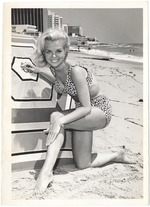 Joyce Scott kneeling next to an umbrella