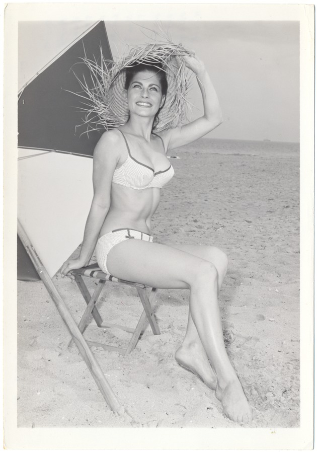 Kitzie Wilson sitting on a stool with a hat enjoying the clear skies - 