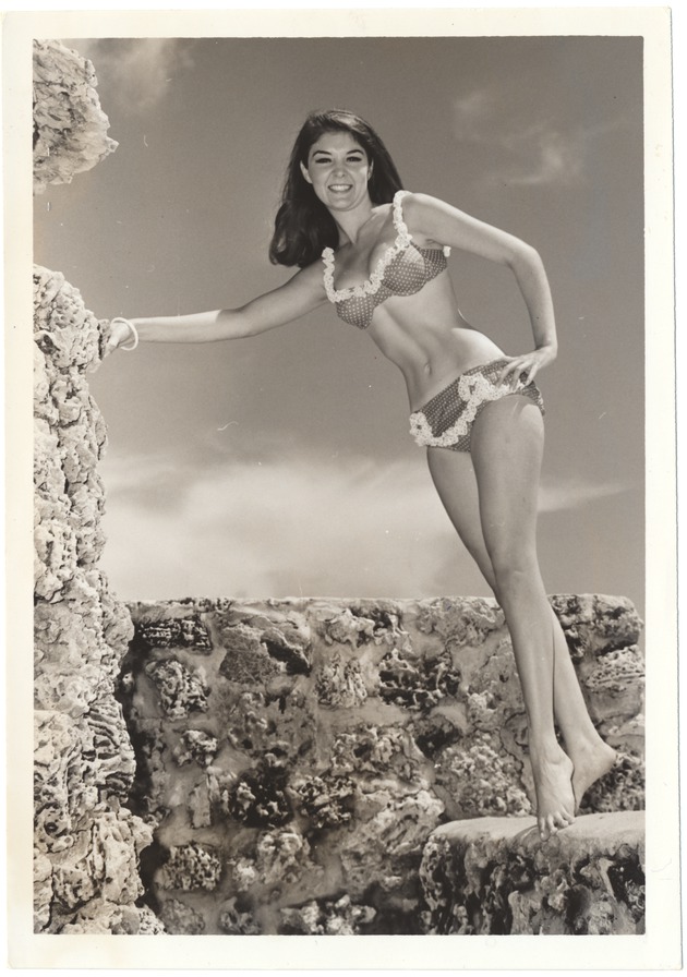 Sandee Panco standing on a coral rock wall - 
