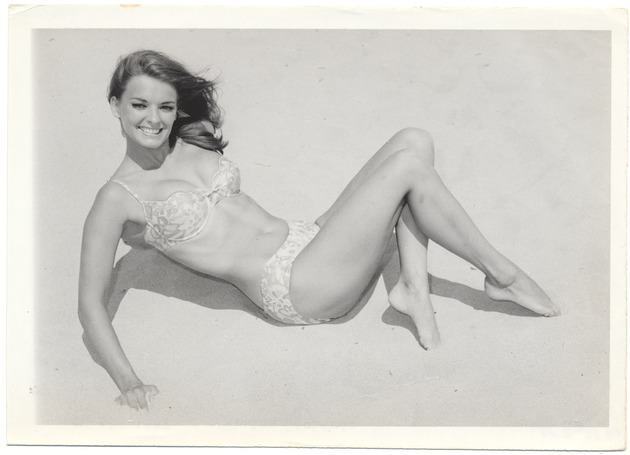 Elaine Richards laying on the sand - 