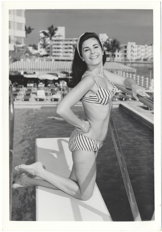 Leslie Mitchell on a diving board at a swimming pool - 