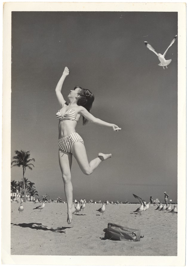 Anette Wright jumping with seagulls in the background - 