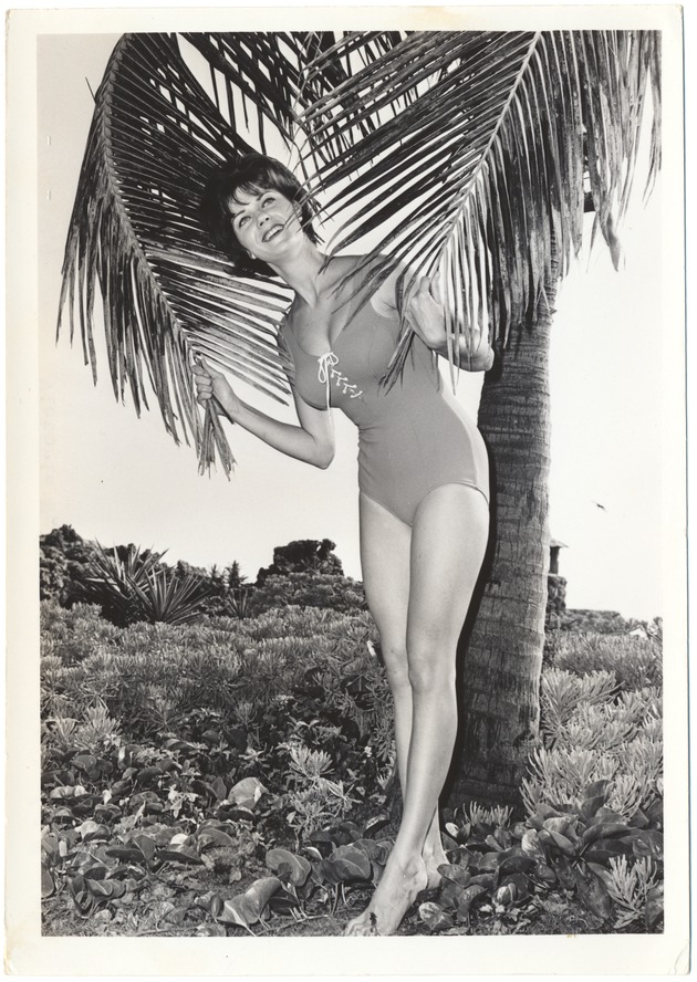 Victoria Wells holding two palm trees - 