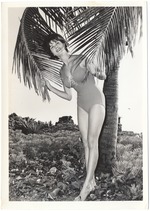 Victoria Wells holding two palm trees