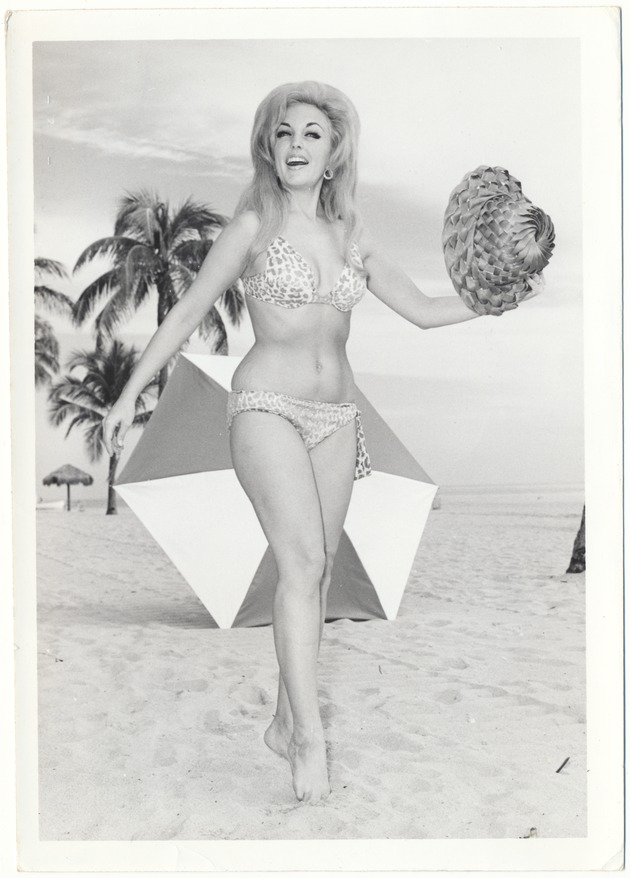 Dawn Wilding at the beach with a hat and an umbrella - 