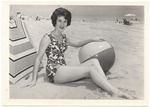 Patti McCully posing with a beach ball and an umbrella