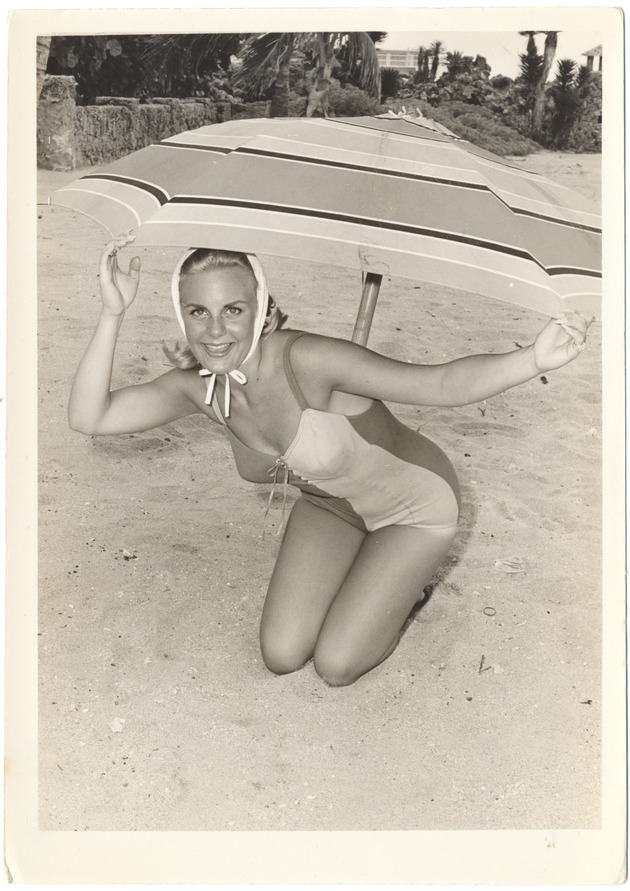Cathie Alexander with a scarf and under a umbrella - 