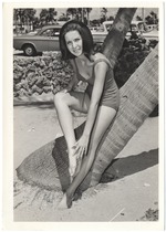 Francine Rubin next to a palm tree in front of parked cars