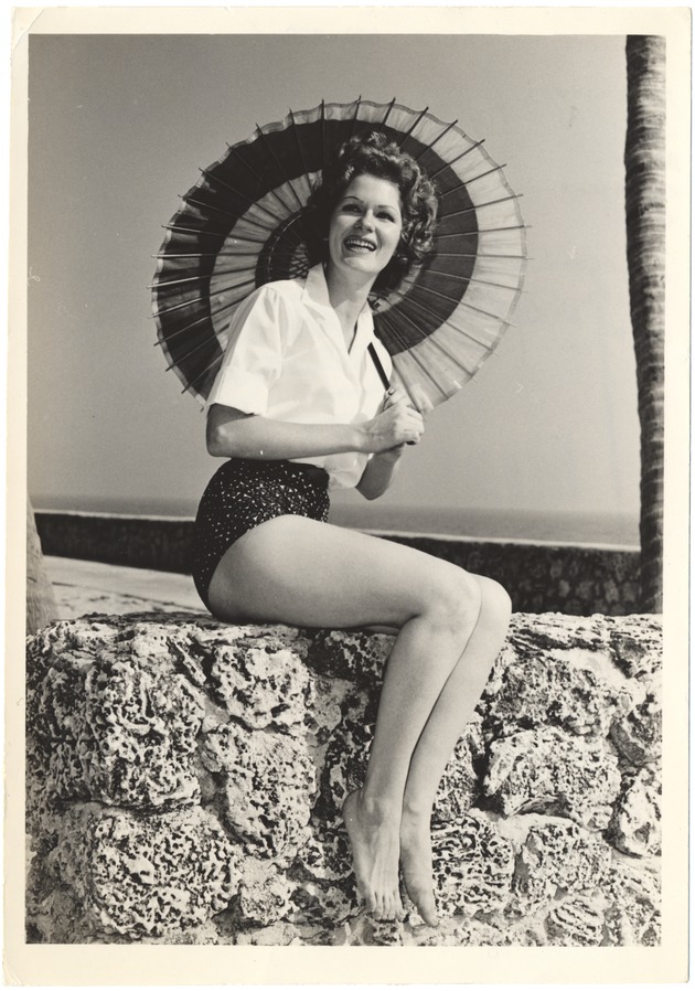 Sue Winters with a parasol on a coral rock - 