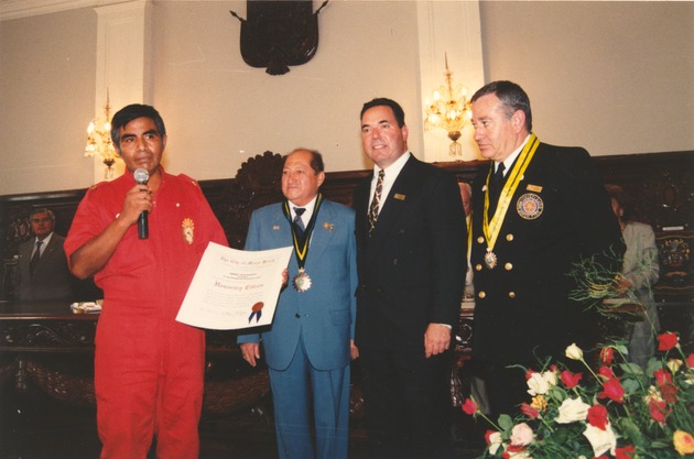 Ica, Peru portraits and scenes from visits - Photograph, recto: [Acceptance ceremony of a donation of motorized firefighting units from Miami Beach to Ica, 2000. Miami Beach Mayor Neisen Kasdin, Ica Mayor Oscar Sanchez Dulanto, and Fire Chief Luis Garcia are pictured (among others)]