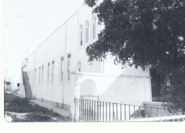 Beth Jacob Congregation, ca. 1960 - Photograph, recto: [Side of Beth Jacob Congregation with stairs leading up to classrooms, ca. 1960s]