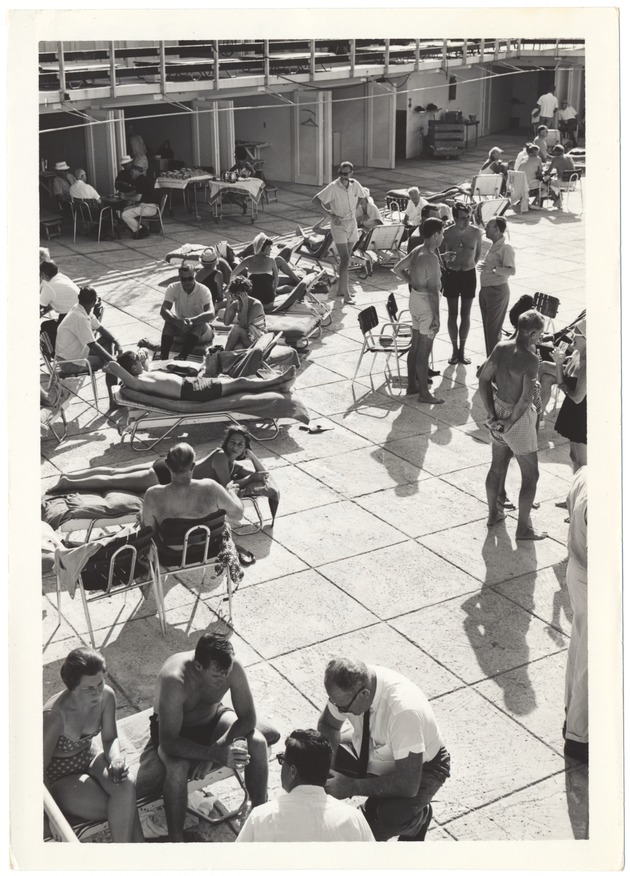 Miami Beach promotional shots of hotel pools and beaches in the 1960s - Photograph, recto: [Sunbathers by a pool]