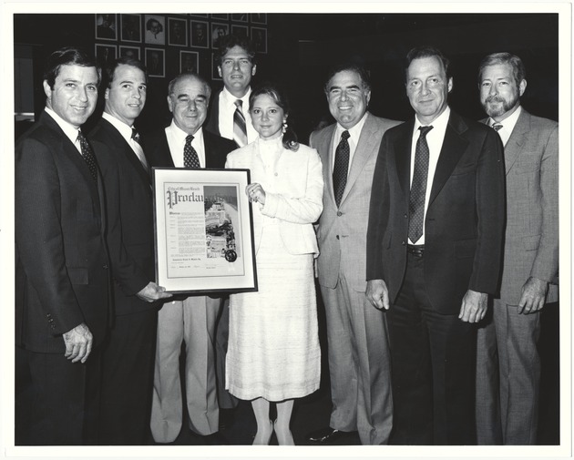 Miami Beach city officials, medal recipients, city employees and volunteers at proclamation ceremonies and pin parties, 1980s - Photograph, recto: [Left to right Malcolm Fromberg, Bruce Singer, unidentified proclamation recipient, Mayor Alex Daoud, unidentified proclamation recipient, Leonard Haber, Sy Eisenberg and Rob Parkins during proclamation ceremony]