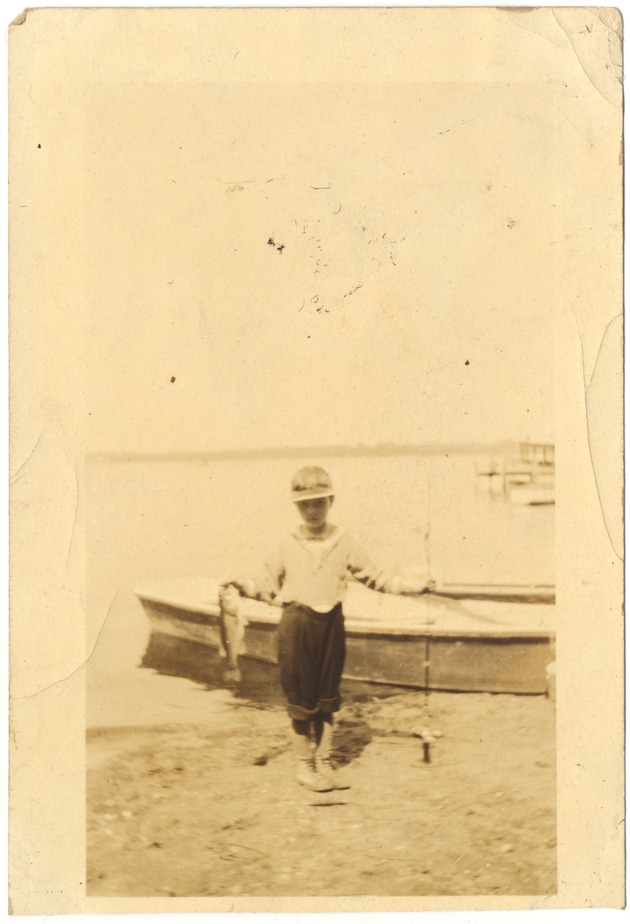 Young boy holding fish - 