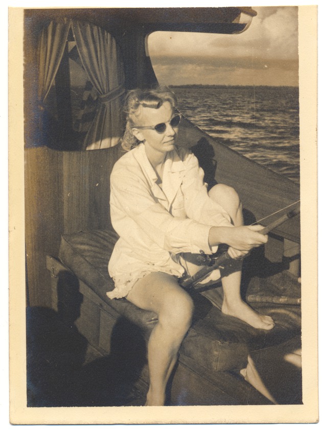 Woman holding fishing pole on boat - 