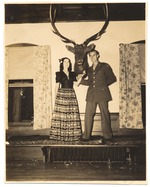 Soldier and woman in front of deer head