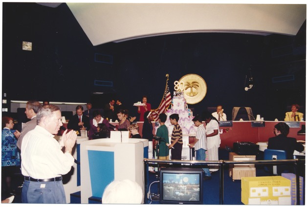 City of Miami Beach 80th Anniversary Celebration - Photograph, recto: [Citizens and city officials at the 80th anniversary of the City of Miami Beach during the cutting of the cake]