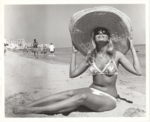 Swimsuit model in various poses on the beach - Photograph, recto: [View of swimsuit model with had on the beach.]