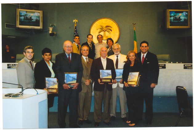 Miami Beach Mayor David Dermer and other city officials presenting awards - Photograph, recto: [City officials Jorge Gonzalez, David Dermer and Matti Bower among others, at an award ceremony]