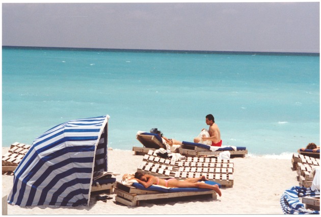 Boardwalk and beach scenes and aerial views, 1990s - Photograph, recto: [View of beach goers and the ocean in the back]