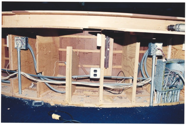 Desks and chairs in the Miami Beach Commission Chambers while under construction, August 1995 - Photograph, recto: [View of tables in the Commission Chamber while under construction]