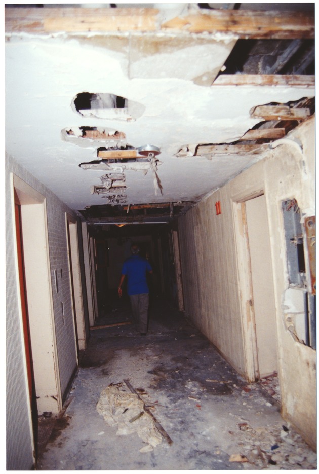 St Moritz Hotel before reconstruction, 1992 - Photograph, recto: [View of the interior of the St. Moritz Hotel before renovation, showing damaged walls]