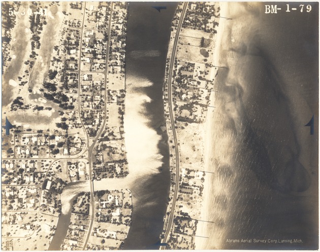 Aerial views of oceanfront buildings in North Miami Beach. Views of estates, hotels, and green areas - Photograph, recto: [Aerial view of Indian Creek and Collins Ave at Flamingo Waterway and Pine Tree Drive]