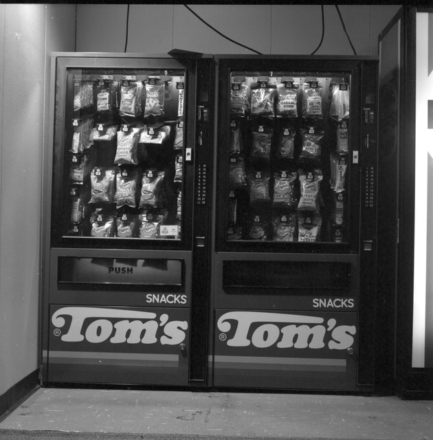 Miami Beach vending machines and posters - Negative: [View of two Tom's snacks vending machines]