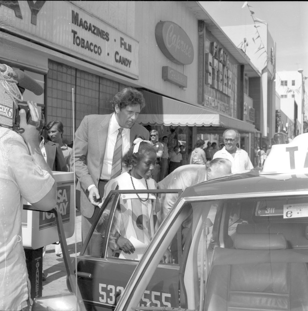Smara Cambridge, Miami Beach Mayor for the Day - Negative: [View of Alex Daoud showing a police car to a girl]