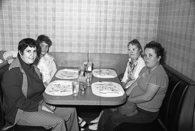 City of Miami Beach community events, 1977 - Negative: [View of four individuals, possibly City of Miami Beach employees, dining in a booth]